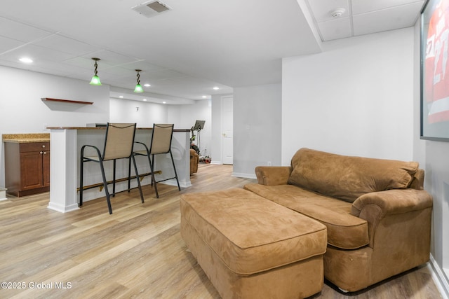 11 Fairview Ln, Halfmoon, NY 12118 - living room featuring wet bar, light wood-style floors, recessed lighting, and a paneled ceiling