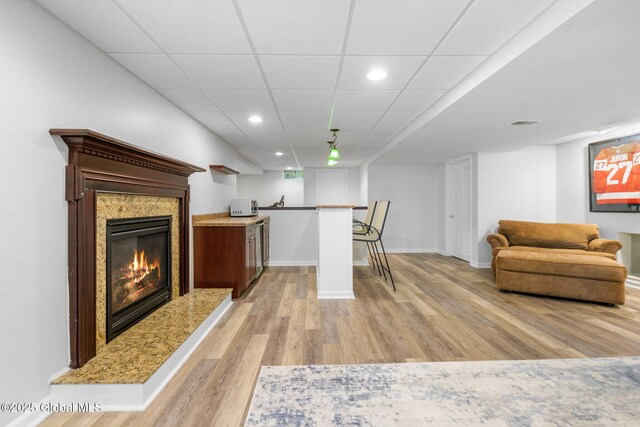 11 Fairview Ln, Halfmoon, NY 12118 - living room featuring light wood-type flooring, bar, recessed lighting, a fireplace, and a drop ceiling