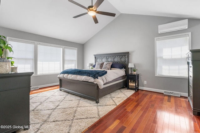 11 Fairview Ln, Halfmoon, NY 12118 - bedroom featuring a wall mounted AC, vaulted ceiling, wood finished floors, multiple windows, and ceiling fan