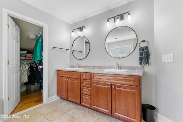 11 Fairview Ln, Halfmoon, NY 12118 - full bath with double vanity, tile patterned floors, and a walk in closet