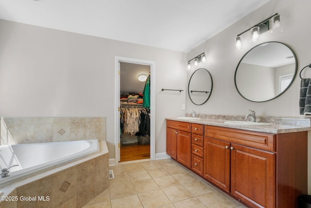 11 Fairview Ln, Halfmoon, NY 12118 - full bathroom with double vanity, tile patterned flooring, a garden tub, and a walk in closet
