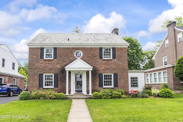 101 Euclid Ave, Albany, NY 12203 - colonial home featuring a front yard, brick siding, and a chimney