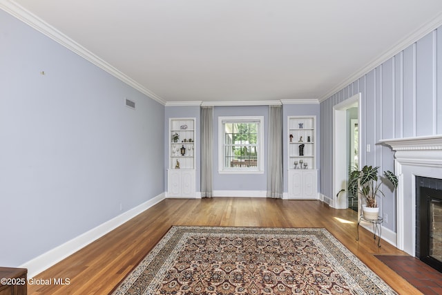 101 Euclid Ave, Albany, NY 12203 - unfurnished living room with wood finished floors, crown molding, a fireplace with flush hearth, and built in features