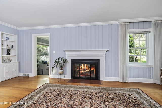 101 Euclid Ave, Albany, NY 12203 - detailed view of wood finished floors, a fireplace with flush hearth, and crown molding