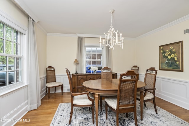 101 Euclid Ave, Albany, NY 12203 - dining space featuring a chandelier, light wood-style floors, healthy amount of natural light, crown molding, and a decorative wall