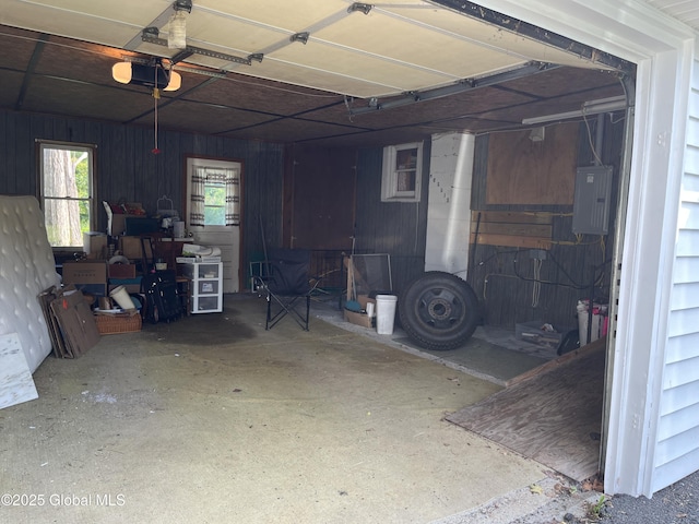65 W Broadway, Salem, NY 12865 - garage featuring electric panel, a garage door opener, and wooden walls