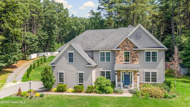 7 Anthony Ln, Saratoga Springs, NY 12866 - traditional-style home featuring stone siding, a front yard, and a porch
