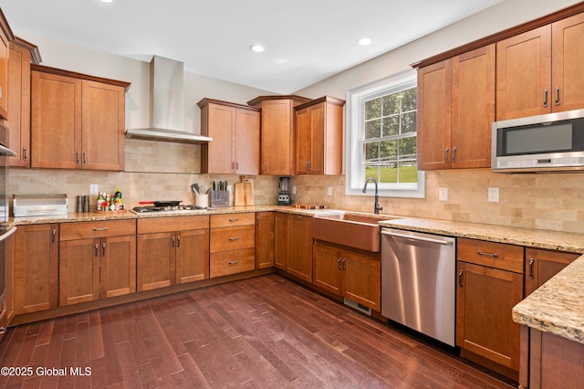 7 Anthony Ln, Saratoga Springs, NY 12866 - kitchen with stainless steel appliances, wall chimney range hood, dark wood-type flooring, brown cabinetry, and recessed lighting