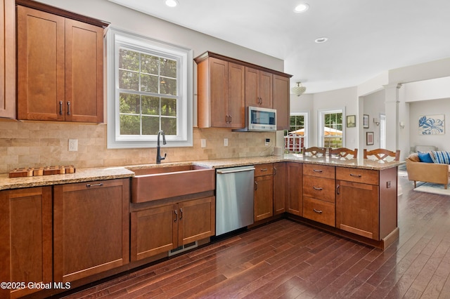 7 Anthony Ln, Saratoga Springs, NY 12866 - kitchen featuring appliances with stainless steel finishes, a peninsula, plenty of natural light, dark wood-style flooring, and recessed lighting