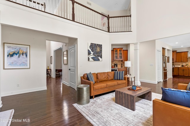 7 Anthony Ln, Saratoga Springs, NY 12866 - living area with a high ceiling, dark wood-type flooring, and decorative columns
