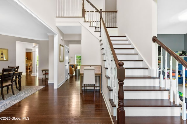 7 Anthony Ln, Saratoga Springs, NY 12866 - stairway featuring hardwood / wood-style flooring, crown molding, and a towering ceiling