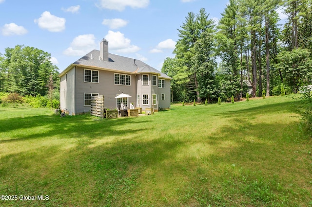 7 Anthony Ln, Saratoga Springs, NY 12866 - rear view of house with a chimney and a lawn