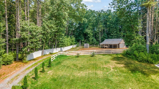 7 Anthony Ln, Saratoga Springs, NY 12866 - view of green lawn with an outbuilding, an exterior structure, and a view of trees