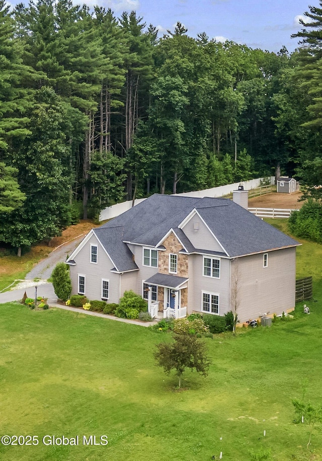 7 Anthony Ln, Saratoga Springs, NY 12866 - view of front of home with a front lawn, a chimney, and roof with shingles