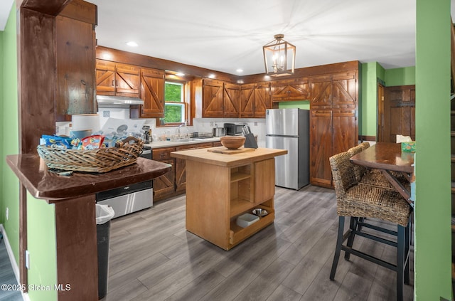 633 Moore Hill Rd, Stephentown, NY 12168 - kitchen with freestanding refrigerator, butcher block counters, light wood finished floors, under cabinet range hood, and pendant lighting