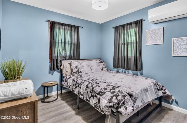 633 Moore Hill Rd, Stephentown, NY 12168 - bedroom with a wall mounted AC and wood finished floors