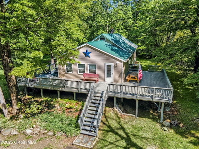 633 Moore Hill Rd, Stephentown, NY 12168 - back of property with a wooden deck, stairway, a wooded view, and a metal roof