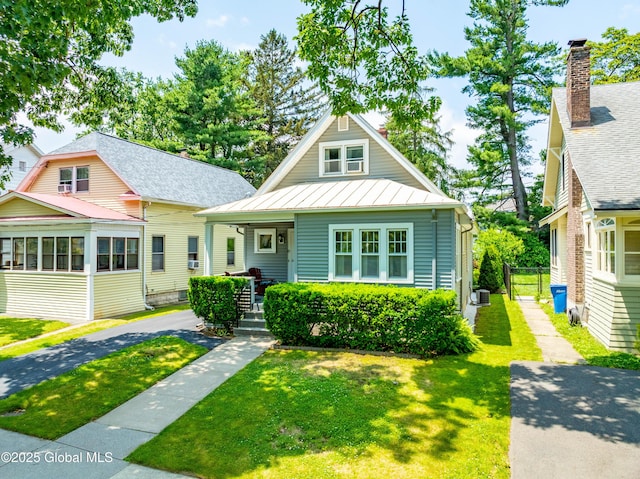 87 Hollywood Ave, Albany, NY 12208 - bungalow-style home with a standing seam roof, a front lawn, a porch, and a metal roof