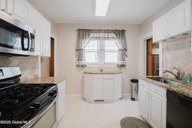 87 Hollywood Ave, Albany, NY 12208 - kitchen with stainless steel appliances, light floors, decorative backsplash, and light stone counters