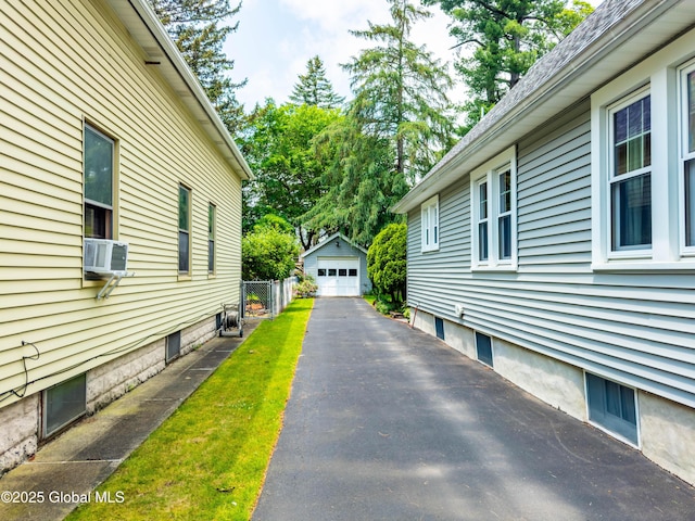 87 Hollywood Ave, Albany, NY 12208 - view of home's exterior featuring driveway, a detached garage, an outbuilding, and cooling unit