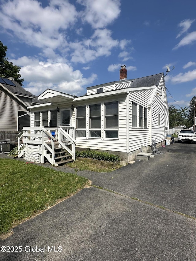 246 Fourteenth St, Schenectady, NY 12306 - view of front of property featuring a chimney, a wooden deck, and asphalt driveway