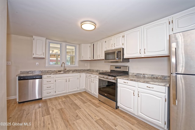 901 Adams St, Rotterdam, NY 12306 - kitchen featuring stainless steel appliances, light wood-type flooring, and white cabinets