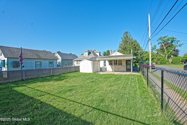 901 Adams St, Rotterdam, NY 12306 - rear view of house featuring a fenced backyard, a patio area, and a shed