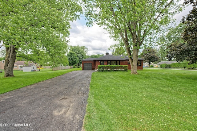 21 Crooked St, Charlton, NY 12019 - single story home with a garage, asphalt driveway, a chimney, brick siding, and a front lawn