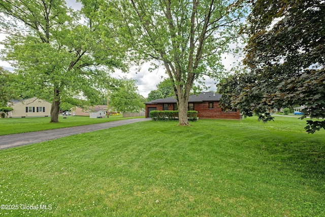 21 Crooked St, Charlton, NY 12019 - ranch-style house featuring driveway, an attached garage, a front yard, and brick siding