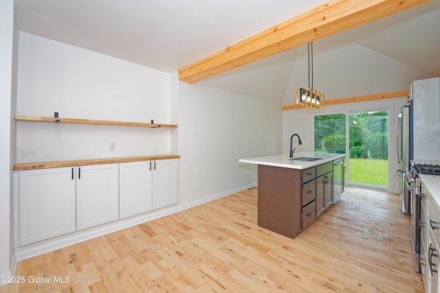 21 Crooked St, Charlton, NY 12019 - kitchen with stainless steel appliances, light wood-style flooring, a center island with sink, lofted ceiling, and hanging light fixtures
