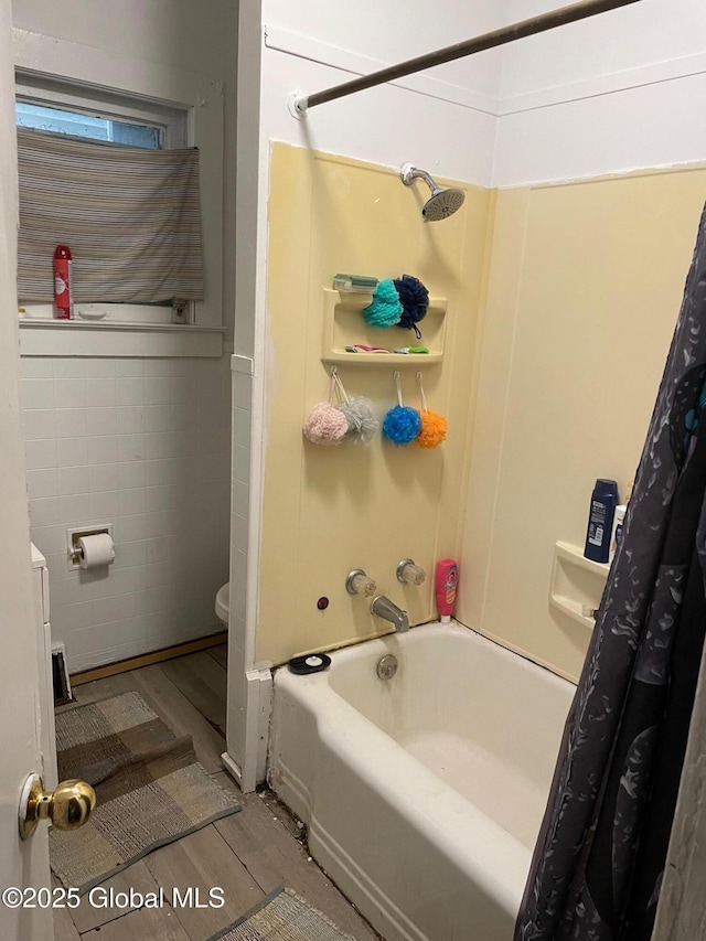 21-25 Mohawk St, Fort Plain, NY 13339 - bathroom with wood finished floors, shower / bath combo, and tile walls