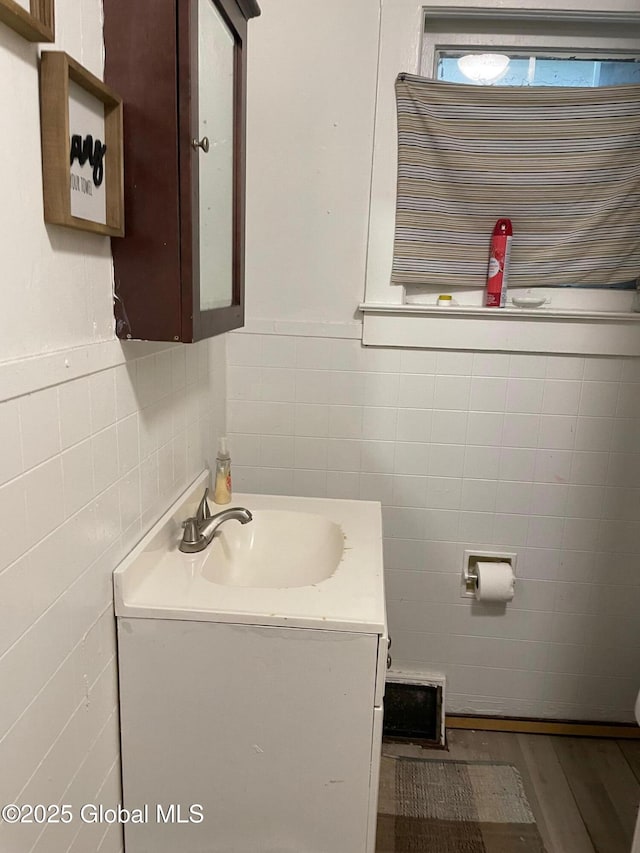 21-25 Mohawk St, Fort Plain, NY 13339 - bathroom with tile walls, vanity, and wood finished floors