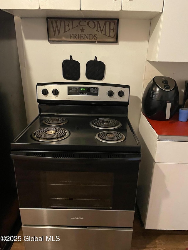 21-25 Mohawk St, Fort Plain, NY 13339 - kitchen view of electric range, washer / clothes dryer, and white cabinets