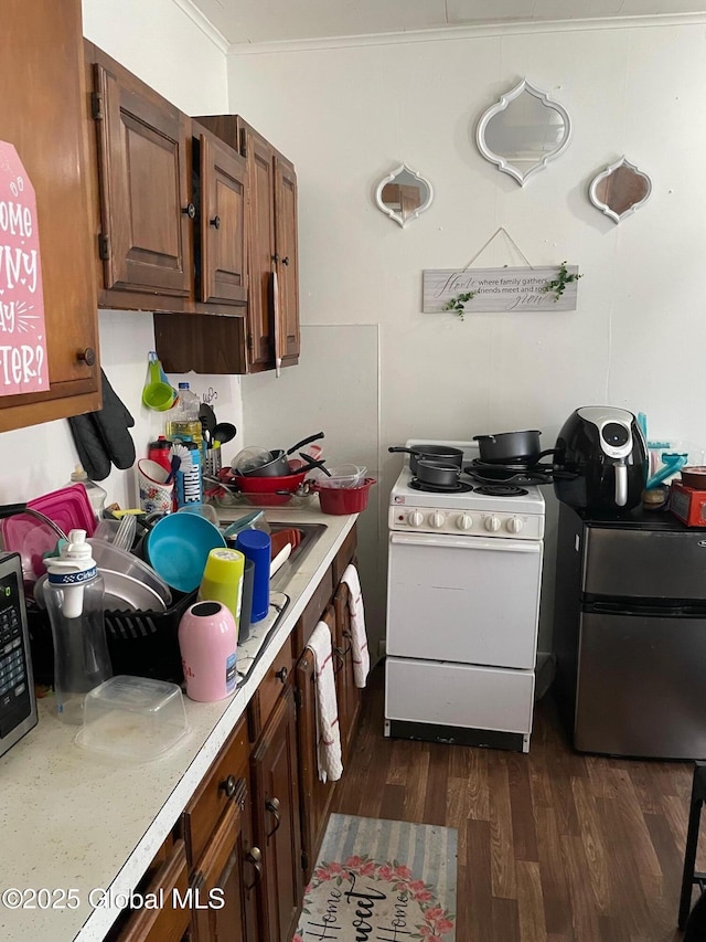 21-25 Mohawk St, Fort Plain, NY 13339 - kitchen with white gas range oven, light countertops, dark wood-type flooring, ornamental molding, and stainless steel microwave