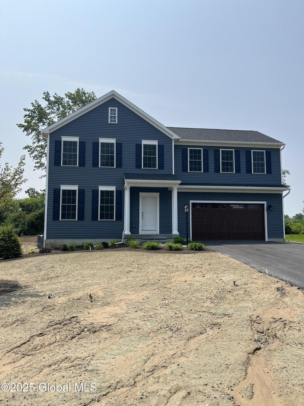 54 Windrow Way, Halfmoon, NY 12118 - view of front of house featuring an attached garage and asphalt driveway