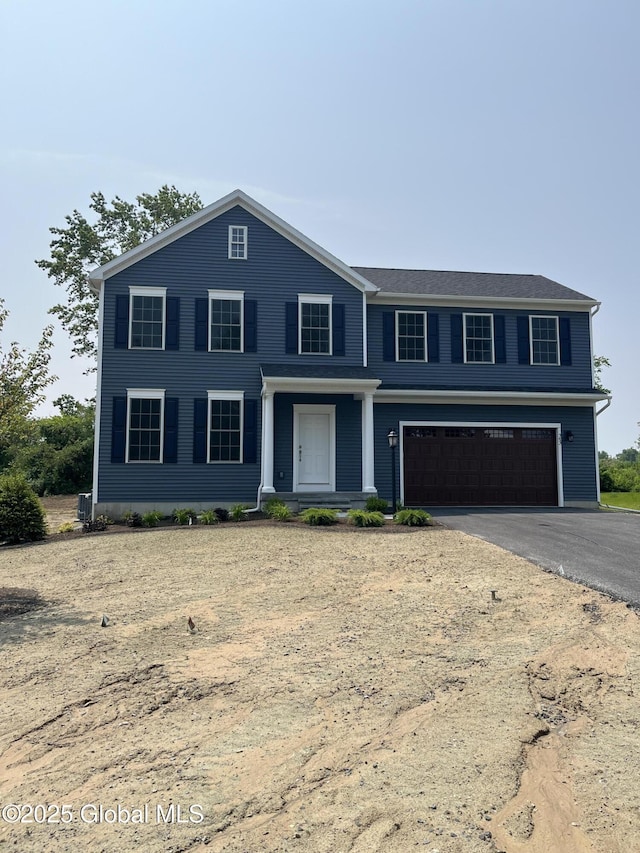 54 Windrow Way, Halfmoon, NY 12118 - view of front of house featuring an attached garage and asphalt driveway