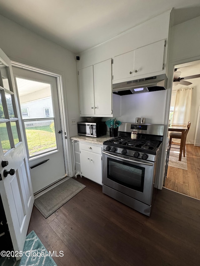 23 Ferry Blvd, South Glens Falls, NY 12803 - kitchen with appliances with stainless steel finishes, under cabinet range hood, dark wood finished floors, white cabinetry, and light countertops