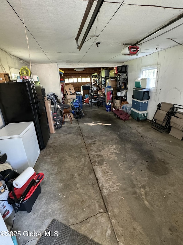 23 Ferry Blvd, South Glens Falls, NY 12803 - garage with a garage door opener, freestanding refrigerator, and fridge