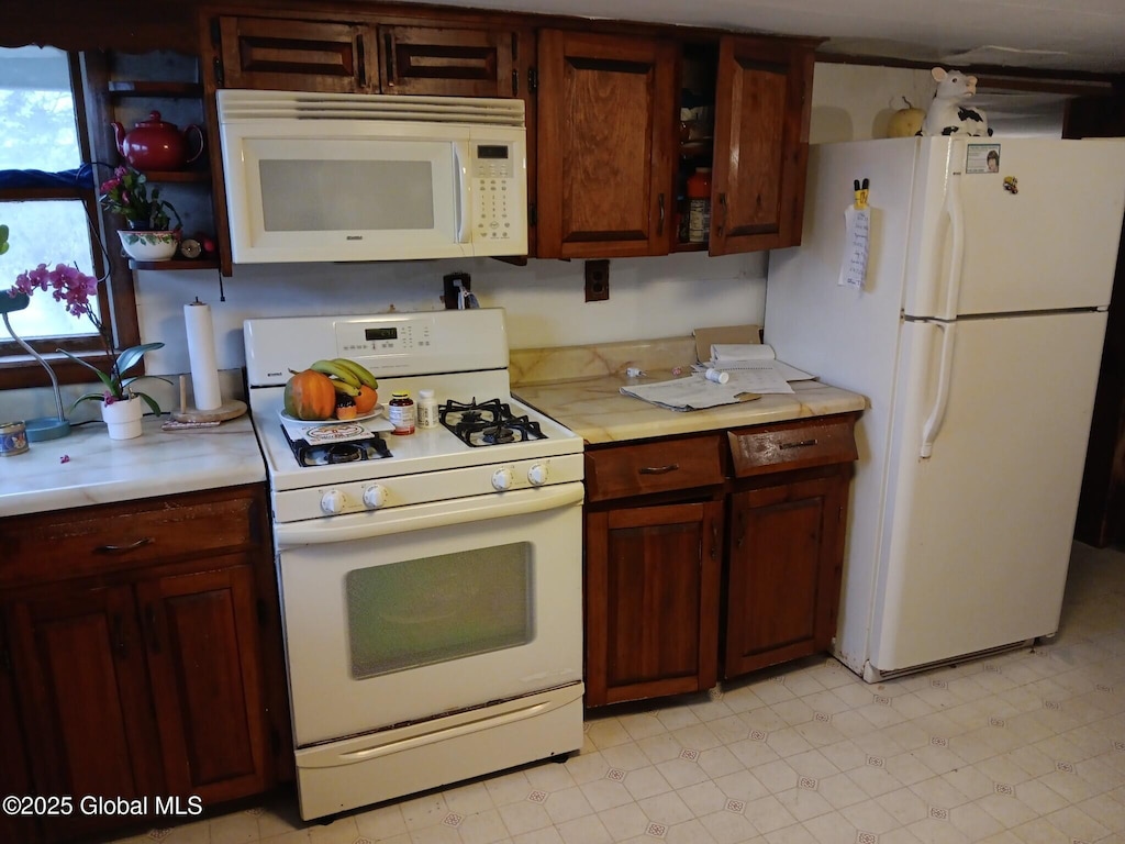 2041 State Highway 162, Charleston, NY 12066 - kitchen featuring white appliances, light countertops, light floors, and open shelves