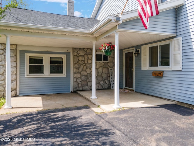 3445 Gari Ln, Guilderland, NY 12303 - entrance to property featuring a shingled roof, stone siding, and covered porch