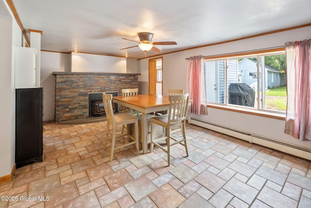 3445 Gari Ln, Guilderland, NY 12303 - dining area featuring a baseboard radiator, ceiling fan, ornamental molding, and a wood stove