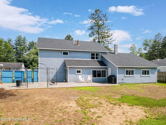 3445 Gari Ln, Guilderland, NY 12303 - rear view of house with a patio area, a chimney, and a shingled roof