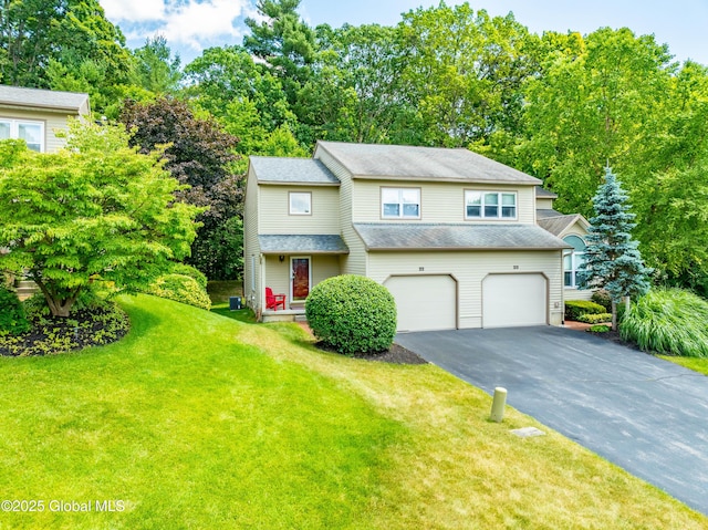 22 Pine Ridge Rd, Stillwater, NY 12866 - view of front of home with asphalt driveway, a garage, a front lawn, and view of scattered trees
