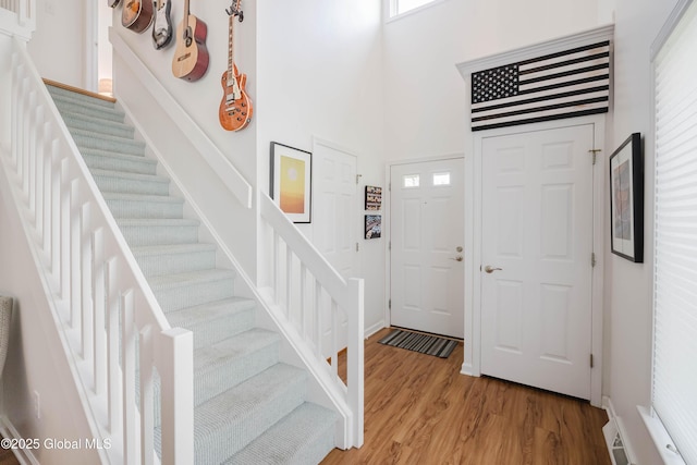 22 Pine Ridge Rd, Stillwater, NY 12866 - entrance foyer featuring stairs, light wood finished floors, and a towering ceiling