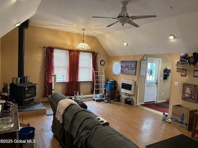634 State Route 143, Westerlo, NY 12193 - living area featuring heating unit, wood finished floors, ceiling fan, lofted ceiling, and a wood stove