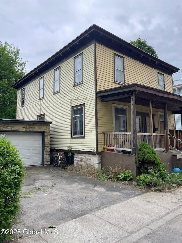 30 Washington St, Fort Plain, NY 13339 - view of home's exterior featuring a porch, an attached garage, and driveway