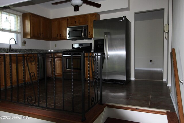 6 Galileo Way, Colonie, NY 12110 - kitchen featuring appliances with stainless steel finishes, ceiling fan, dark tile patterned floors, and dark stone counters