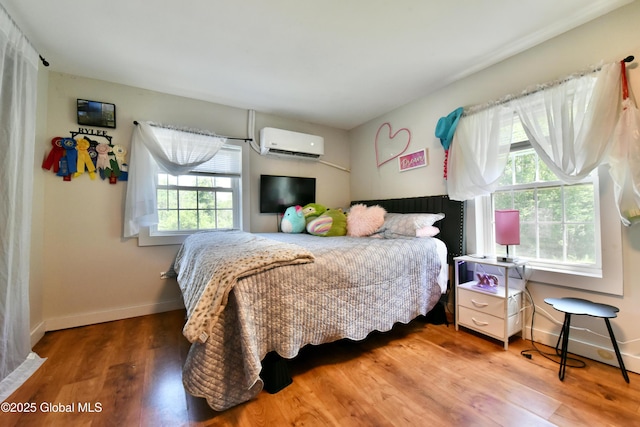 157 Mosquito Swamp Rd, Greenwich, NY 12834 - bedroom with a wall unit AC, multiple windows, and wood finished floors