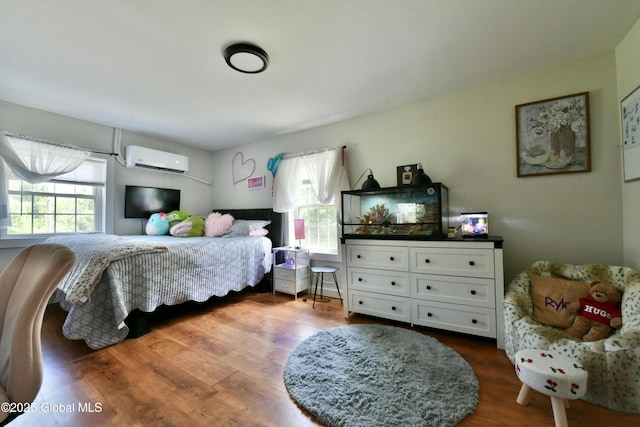 157 Mosquito Swamp Rd, Greenwich, NY 12834 - bedroom featuring a wall unit AC, multiple windows, and wood finished floors