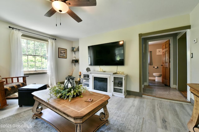 157 Mosquito Swamp Rd, Greenwich, NY 12834 - living room with a ceiling fan, a glass covered fireplace, and light wood-style floors